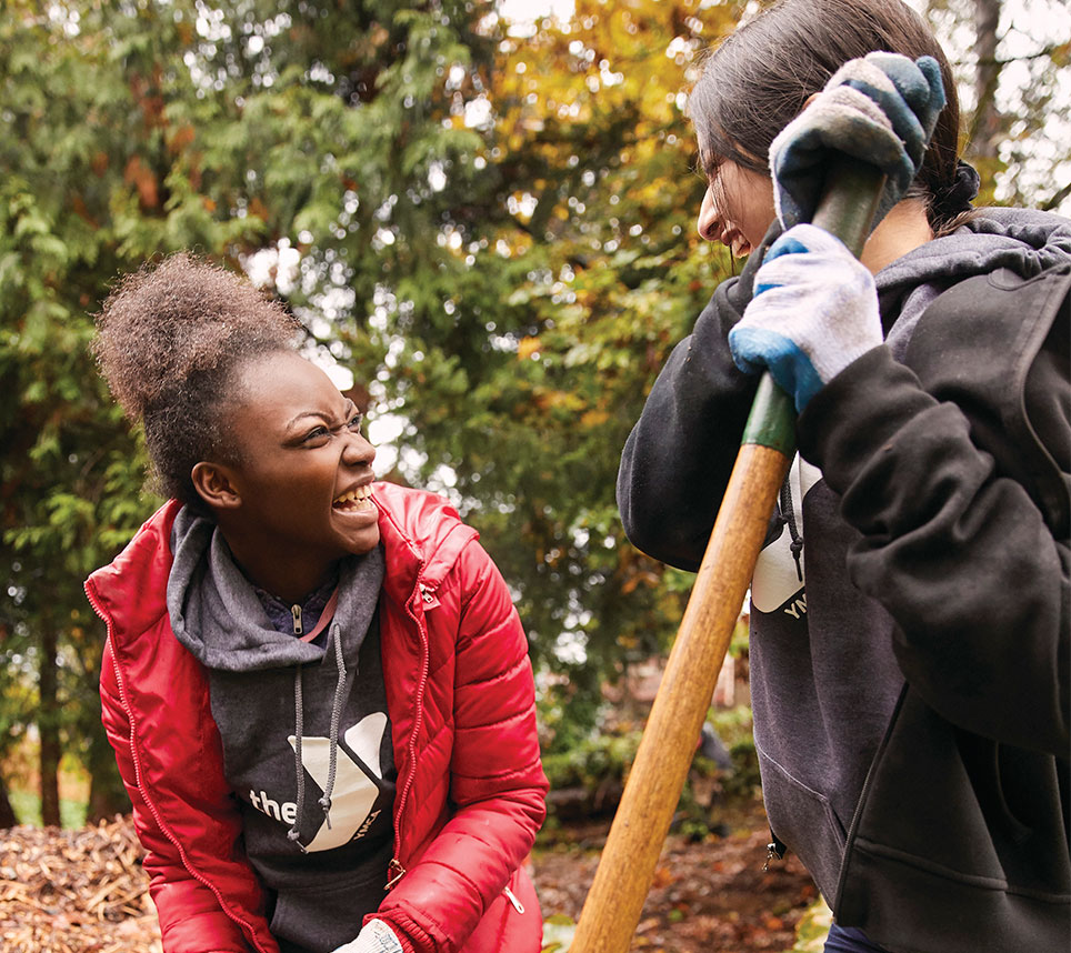 Volunteers smiling during yard clean up