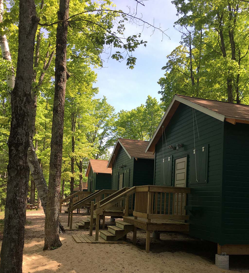 A row of green cabins for Camp AGQ