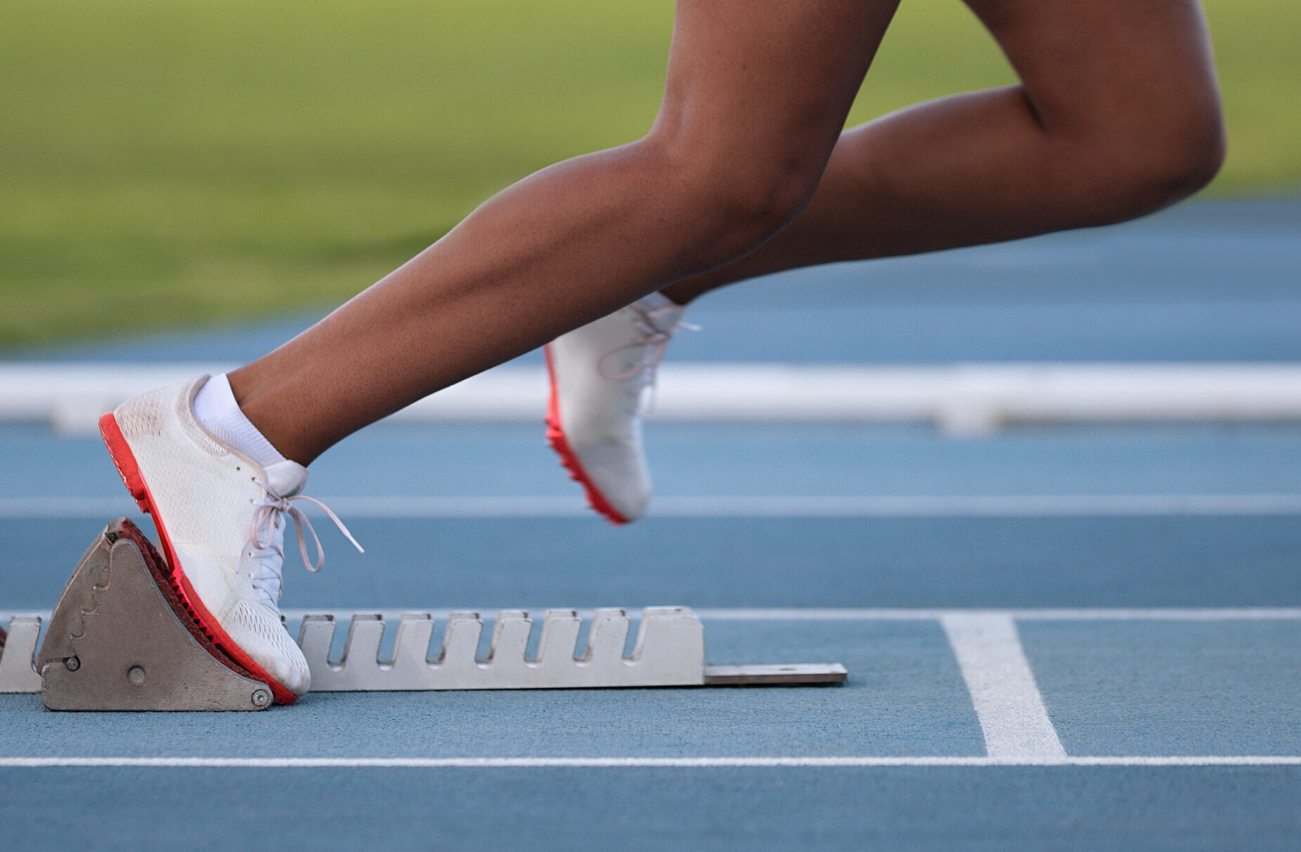 Athlete leaving starting blocks on the athletic track
